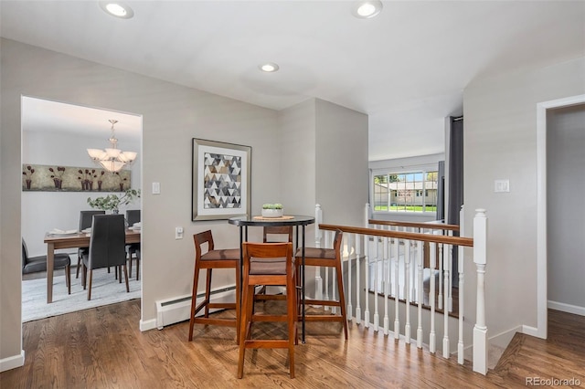 6150 S Southwood Dr, Centennial, CO 80121 - dining area with a baseboard radiator, wood finished floors, a chandelier, baseboards, and recessed lighting