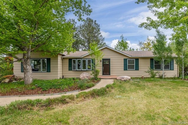 ranch-style house with a front lawn