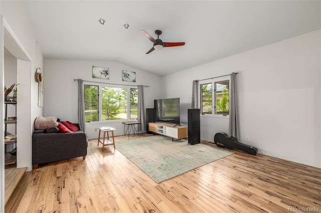 living room with lofted ceiling, ceiling fan, light hardwood / wood-style floors, and a healthy amount of sunlight