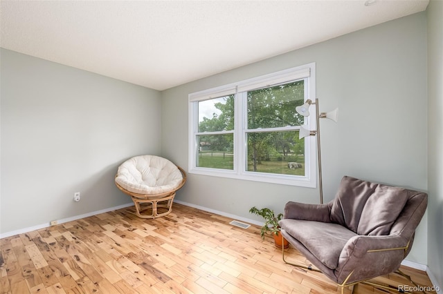 sitting room featuring light hardwood / wood-style flooring