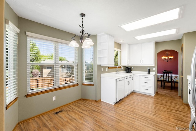 19817 E Prentice Ave, Centennial, CO 80015 - kitchen with a chandelier, light wood-style flooring, a sink, white cabinets, and healthy amount of natural light
