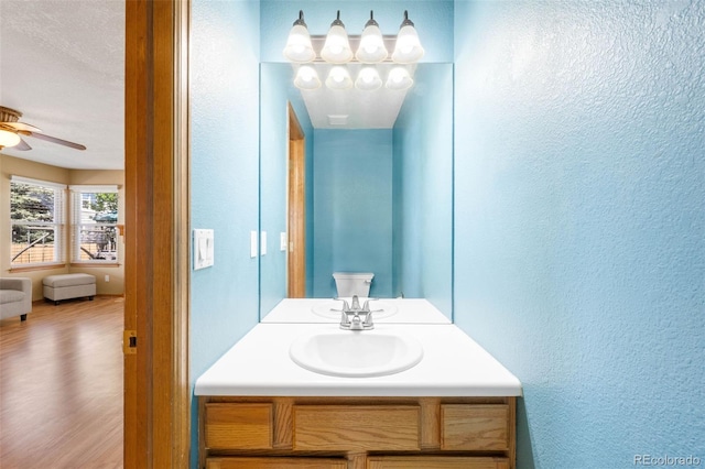 19817 E Prentice Ave, Centennial, CO 80015 - bathroom featuring a textured wall, ceiling fan, vanity, and wood finished floors