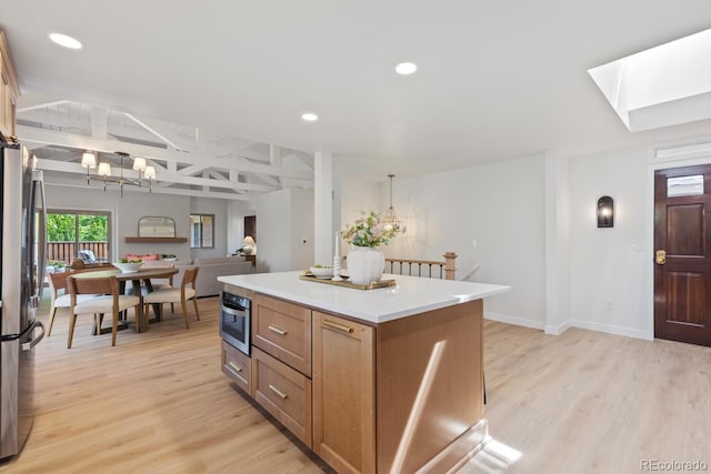 41 Eagle Dr, Littleton, CO 80123 - kitchen with a chandelier, stainless steel appliances, a kitchen island, light wood-type flooring, and recessed lighting