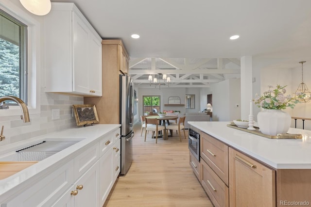 41 Eagle Dr, Littleton, CO 80123 - kitchen with freestanding refrigerator, light wood-type flooring, backsplash, light countertops, and a sink