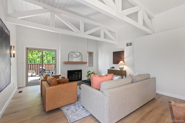 41 Eagle Dr, Littleton, CO 80123 - living room with high vaulted ceiling, baseboards, a fireplace, beamed ceiling, and wood finished floors