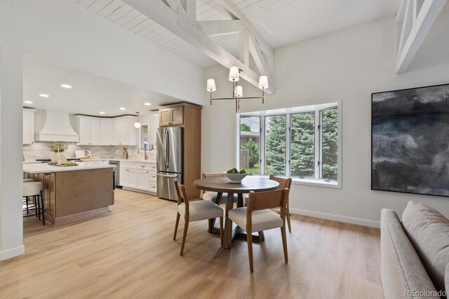 41 Eagle Dr, Littleton, CO 80123 - dining room featuring light wood-style floors, baseboards, high vaulted ceiling, beam ceiling, and recessed lighting