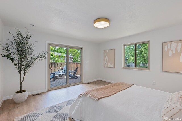 41 Eagle Dr, Littleton, CO 80123 - bedroom featuring multiple windows, wood finished floors, and access to exterior
