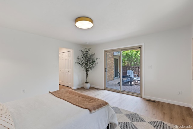 41 Eagle Dr, Littleton, CO 80123 - bedroom with light wood-style floors, baseboards, and access to exterior