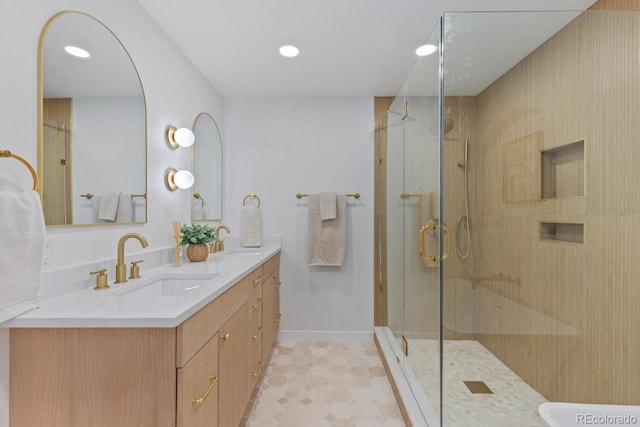 41 Eagle Dr, Littleton, CO 80123 - full bathroom with double vanity, a stall shower, baseboards, and recessed lighting