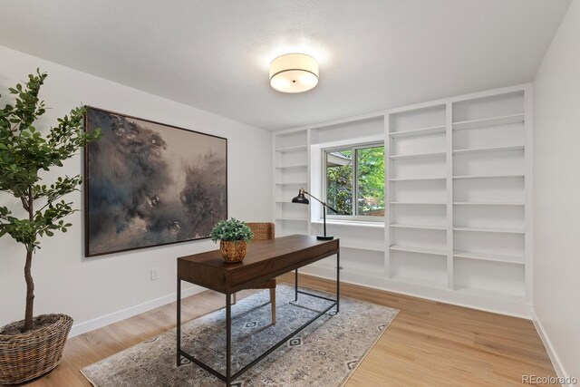 41 Eagle Dr, Littleton, CO 80123 - office area featuring built in shelves, light wood finished floors, and baseboards