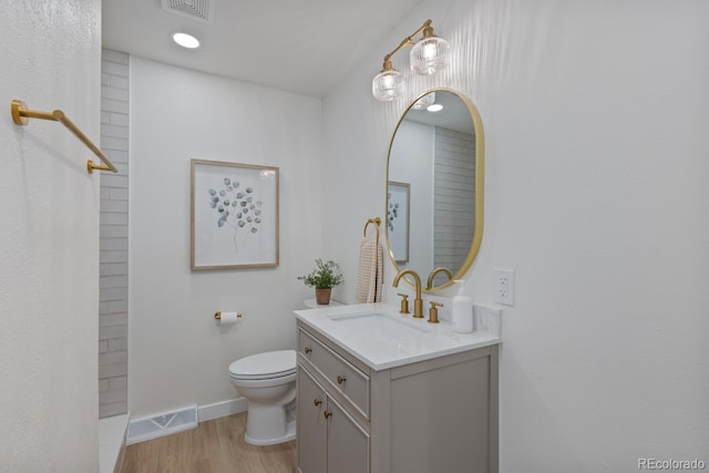 41 Eagle Dr, Littleton, CO 80123 - bathroom featuring vanity, toilet, wood finished floors, and baseboards
