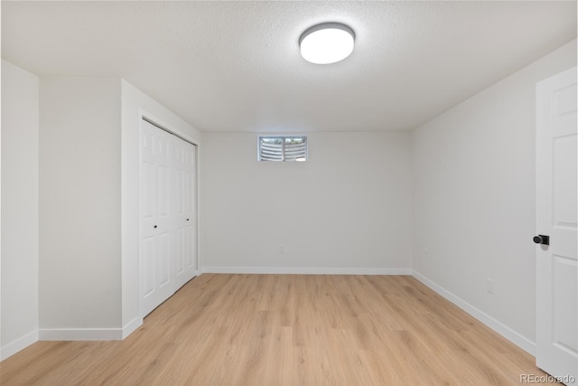 41 Eagle Dr, Littleton, CO 80123 - below grade area featuring light wood-style flooring, baseboards, and a textured ceiling