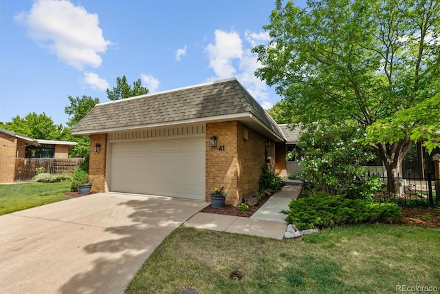 41 Eagle Dr, Littleton, CO 80123 - view of front of property with brick siding, driveway, and a shingled roof