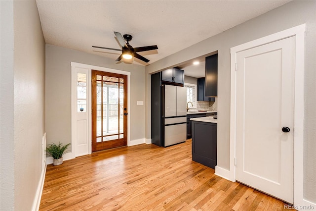 1945 Yosemite St, Denver, CO 80220 - entrance foyer with light wood-style floors, a ceiling fan, and baseboards