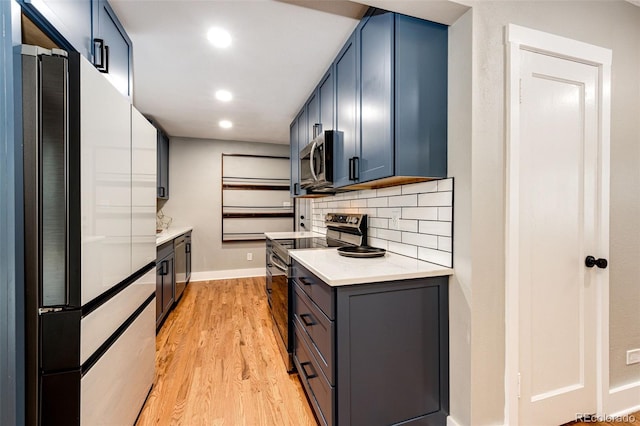 1945 Yosemite St, Denver, CO 80220 - kitchen featuring stainless steel appliances, light wood finished floors, light countertops, backsplash, and baseboards