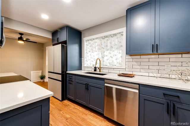1945 Yosemite St, Denver, CO 80220 - kitchen featuring stainless steel dishwasher, freestanding refrigerator, a sink, a ceiling fan, and backsplash