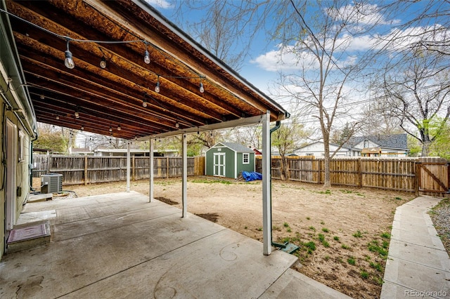 1945 Yosemite St, Denver, CO 80220 - view of patio featuring cooling unit, a shed, a fenced backyard, and an outbuilding