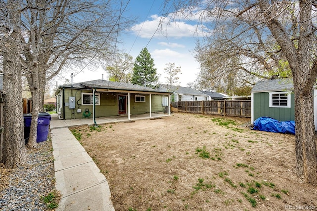 1945 Yosemite St, Denver, CO 80220 - rear view of house featuring a fenced backyard and a patio area