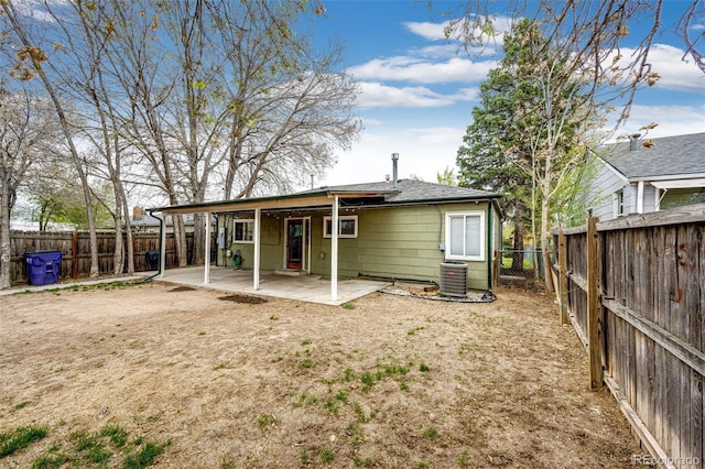 1945 Yosemite St, Denver, CO 80220 - rear view of house with central AC, a patio area, a fenced backyard, and roof with shingles