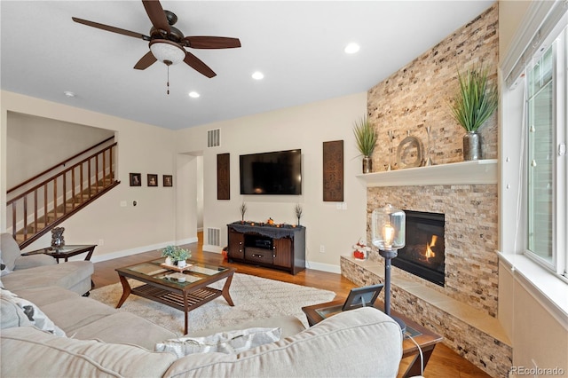 15003 W 63rd Ave, Arvada, CO 80403 - living room with stairs, a ceiling fan, plenty of natural light, a stone fireplace, and recessed lighting
