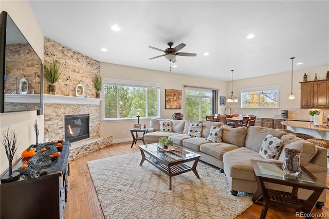 15003 W 63rd Ave, Arvada, CO 80403 - living area with recessed lighting, a fireplace, ceiling fan, and light wood-type flooring
