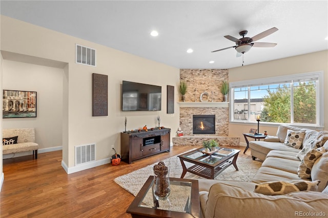 15003 W 63rd Ave, Arvada, CO 80403 - living area with wood finished floors, recessed lighting, a fireplace, and a ceiling fan