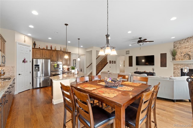15003 W 63rd Ave, Arvada, CO 80403 - dining area featuring stairway, wood finished floors, a ceiling fan, and recessed lighting
