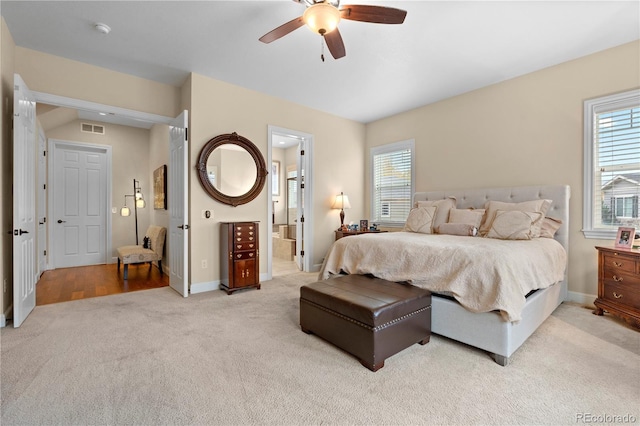 15003 W 63rd Ave, Arvada, CO 80403 - bedroom with light colored carpet, multiple windows, a ceiling fan, and ensuite bathroom