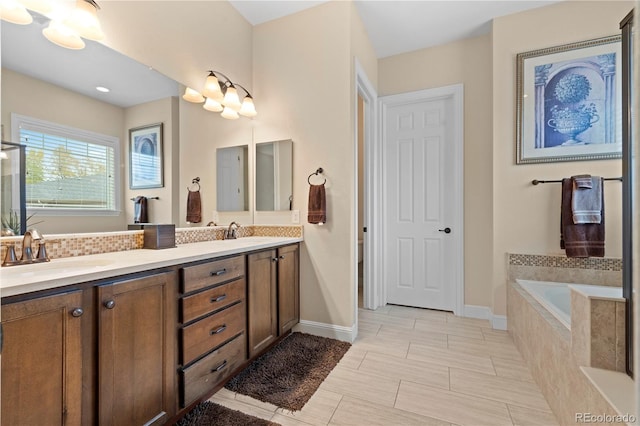 15003 W 63rd Ave, Arvada, CO 80403 - bathroom featuring double vanity, a bath, and tasteful backsplash