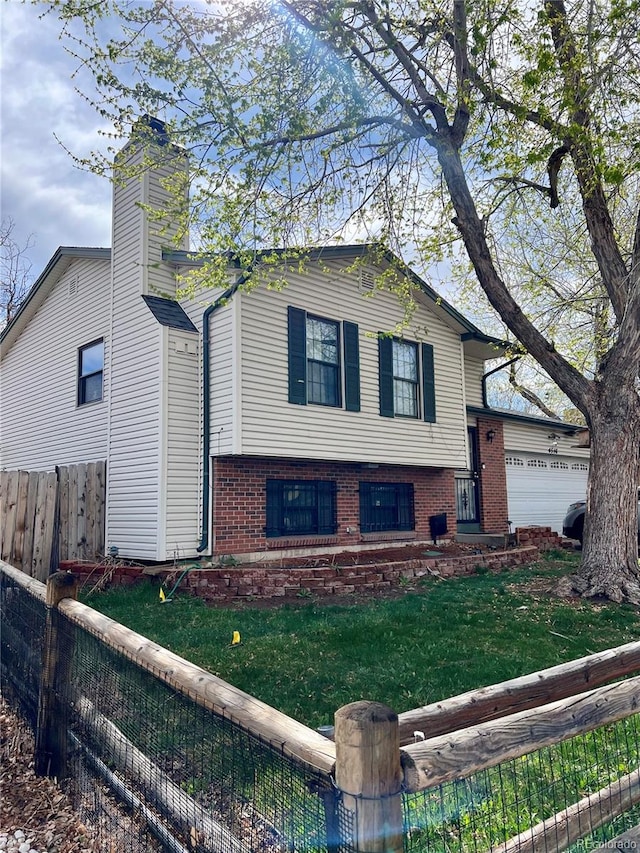 view of front of house with a garage and a front yard