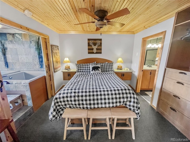 bedroom with dark colored carpet, wooden ceiling, crown molding, ensuite bathroom, and ceiling fan