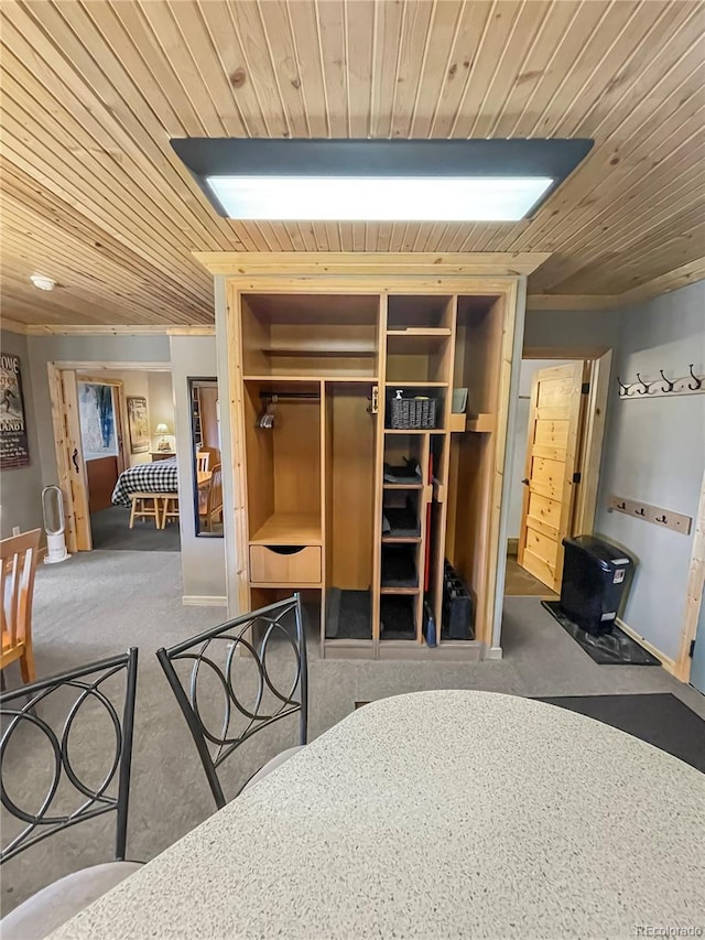 bedroom featuring dark carpet and wood ceiling