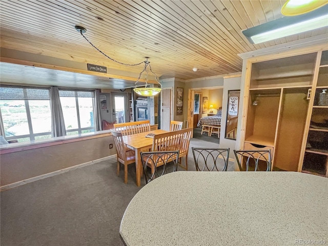 carpeted dining area featuring crown molding and wooden ceiling