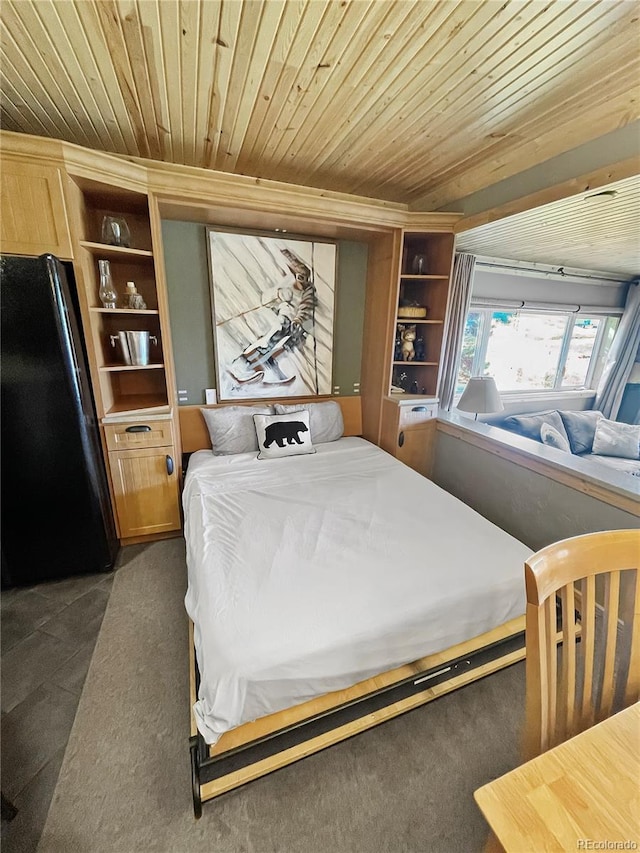 bedroom with wooden ceiling and black fridge