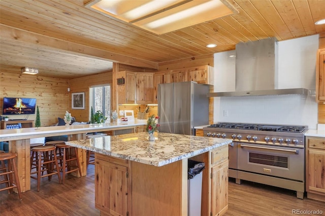 70 Sheep Creek Trl, Fairplay, CO 80440 - kitchen with appliances with stainless steel finishes, wall chimney range hood, wooden ceiling, wood finished floors, and backsplash