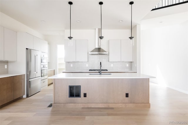 11324 Alla Breve Cir, Lone Tree, CO 80134 - kitchen featuring modern cabinets, high end refrigerator, wall chimney range hood, and recessed lighting