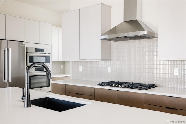 11324 Alla Breve Cir, Lone Tree, CO 80134 - kitchen featuring wall chimney exhaust hood, stainless steel appliances, light countertops, and modern cabinets