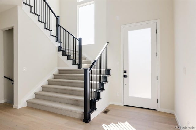 11324 Alla Breve Cir, Lone Tree, CO 80134 - entrance foyer featuring wood finished floors, stairs, and a towering ceiling