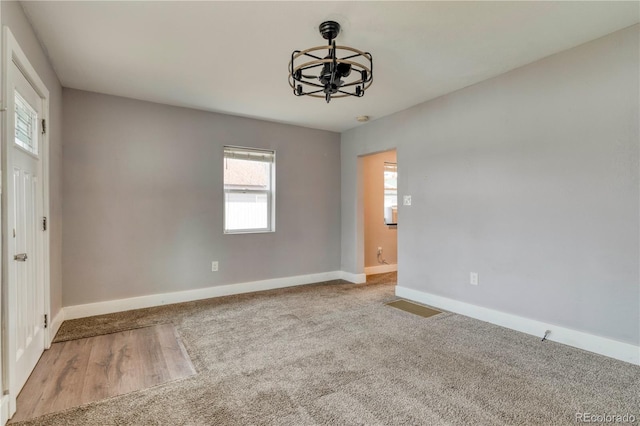 6660 Locust St, Commerce City, CO 80022 - carpeted empty room featuring an inviting chandelier, baseboards, and visible vents