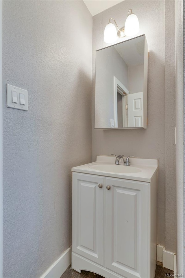 6660 Locust St, Commerce City, CO 80022 - bathroom featuring vanity and a textured wall