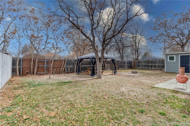 6660 Locust St, Commerce City, CO 80022 - view of yard with an outbuilding, a patio, a fenced backyard, an outdoor fire pit, and a gazebo