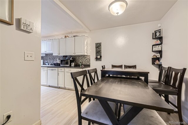 3550 S Harlan St Unit 311, Denver, CO 80235 - dining room featuring light wood finished floors