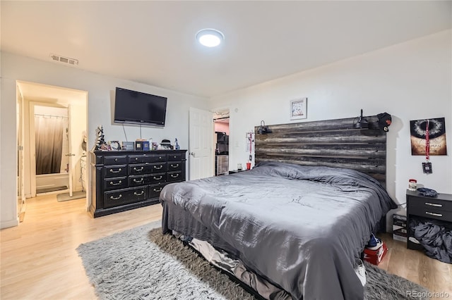 3550 S Harlan St Unit 311, Denver, CO 80235 - bedroom with wood finished floors and connected bathroom