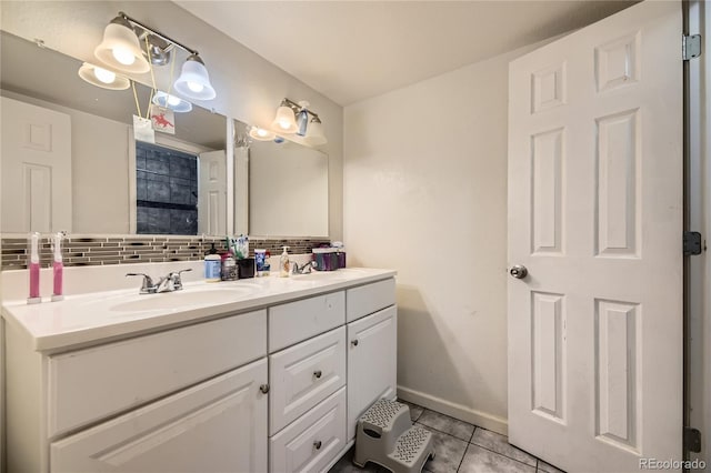 3550 S Harlan St Unit 311, Denver, CO 80235 - full bath with tile patterned flooring, tasteful backsplash, double vanity, and baseboards