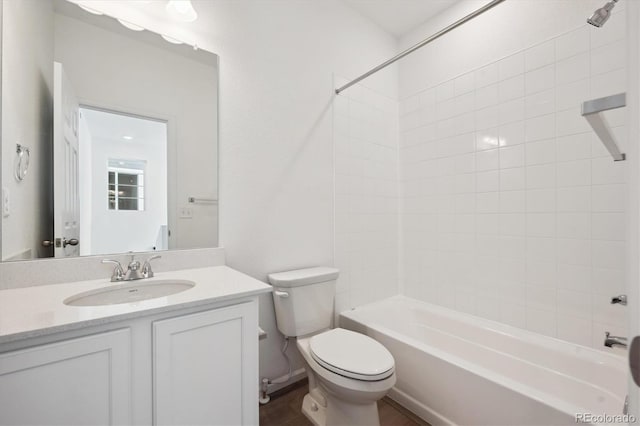 bathroom with shower / bathtub combination, toilet, and vanity