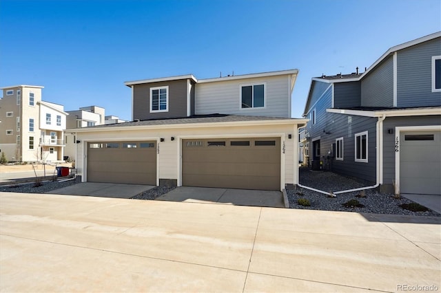 view of front of house featuring concrete driveway and an attached garage