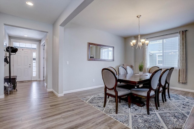 dining room with hardwood / wood-style flooring and a chandelier