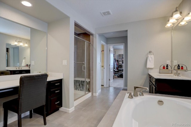 bathroom featuring tile patterned floors, vanity, and a shower with door