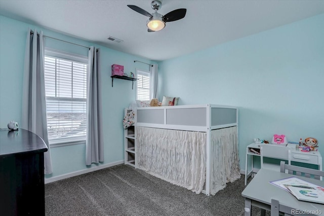 bedroom featuring ceiling fan and dark colored carpet