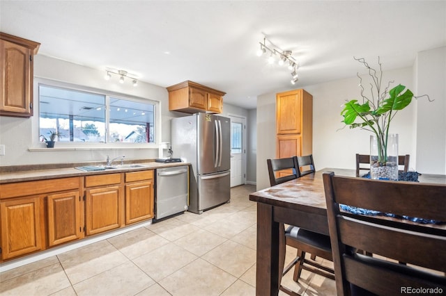 kitchen featuring stainless steel appliances, sink, and light tile patterned floors